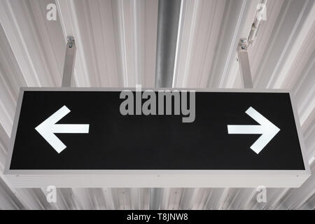 empty sign mockup on ceiling / blank sign mock-up with arrows Stock Photo