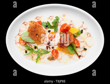 Octopus carpaccio in plate isolated on black background Stock Photo