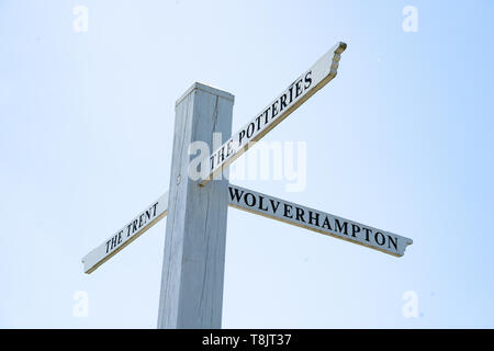 Wooden signpost for The Potteries, The Trent, Wolverhampton on the junction of the Trent and Mersey canal and the Staffordshire and Worcester canal Stock Photo