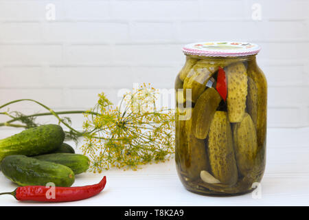 Marinated cucumbers in jars on a white background, harvest for the winter, Free place for the inscription Stock Photo