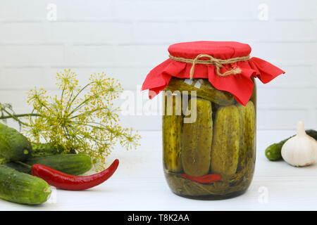 Marinated cucumbers in jars on a white background, harvest for the winter, Free place for the inscription Stock Photo