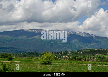Springtime scene with mountain glade, forest and residential district of bulgarian village Plana at Plana mountain near Vitosha mountain,  Bulgaria Stock Photo
