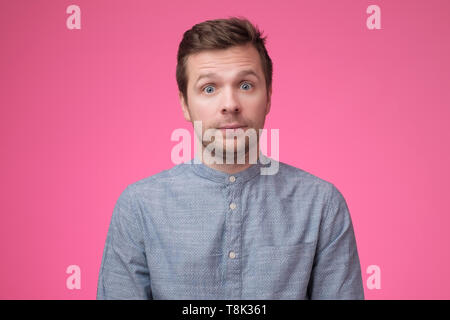 Stunned face of caucasian man in blue shirt. Stock Photo