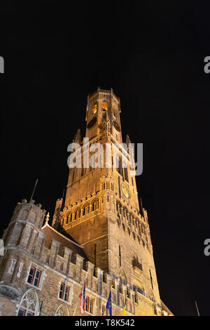 Night view on the illuminated Belfry of Bruges, the medieval bell tower. The 83 meter high belfry or hallstower (halletoren) is Bruges' most well-know Stock Photo