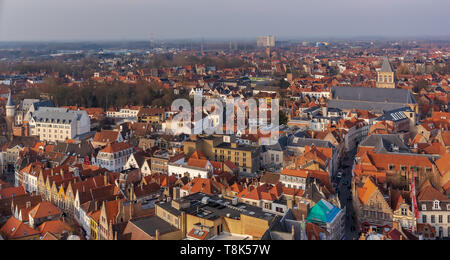 Fantastic Bruges city skyline with red tiled roofs and St. James's Church (Sint-Jakobskerk) in sunny winter day. View to Bruges medieval cityscape fro Stock Photo