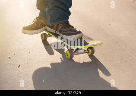 man in jeans and sneakers on a skateboard Stock Photo