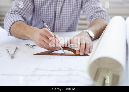 Engineer Drawing Plans at Workplace Stock Photo