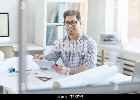 Smiling Engineer Using Digital Tablet Stock Photo