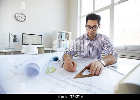 Young Engineer Drawing Plans Stock Photo