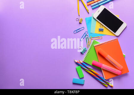 Set of school stationery with mobile phone on color background Stock Photo