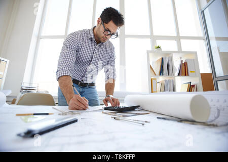 Middle-Eastern Engineer Drawing Plans Stock Photo