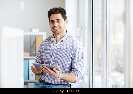 Middle-Eastern Man Holding Tablet Stock Photo