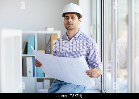 Middle-Eastern Engineer Holding Plans Stock Photo