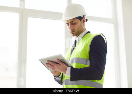 Middle-Eastern Engineer Holding Tablet Stock Photo