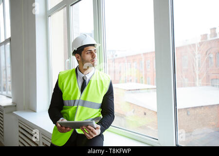 Pensive Businessman on Construction Site Stock Photo