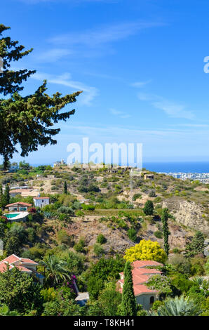 Vertical picture of amazing coastal landscape in Kyrenia region, Northern Cyprus. Rural houses surrounded by green trees are overlooking the sea Stock Photo