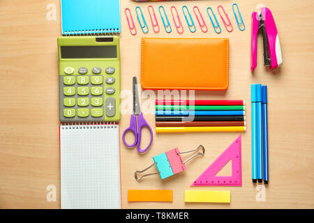 Composition with different school stationery and calculator on wooden background Stock Photo