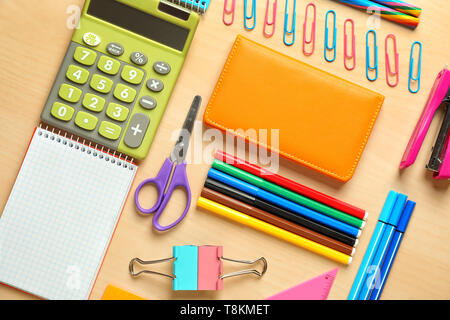 Composition with different school stationery and calculator on wooden background Stock Photo