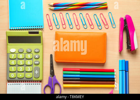 Composition with different school stationery and calculator on wooden background Stock Photo