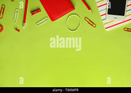Composition with different school stationery and mobile phone on color background Stock Photo