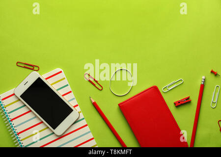 Composition with different school stationery and mobile phone on color background Stock Photo