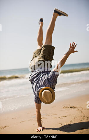 handstand at the shore naked man doing a handstand Stock Photo - Alamy