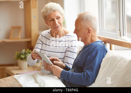 Modern Senior Couple Using Tablet Stock Photo
