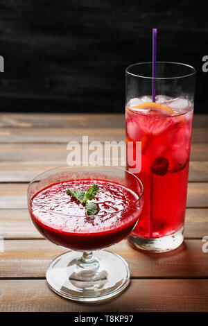 Glass of fresh raspberry lemonade and bowl with honey on white ...