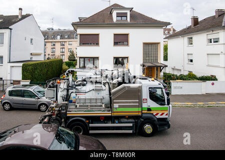 Paris, France - Apr 24, 2019: New Sewage truck on city street in working process to clean up sewerage overflows, cleaning pipelines and potential pollution issues Stock Photo