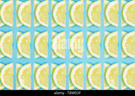 Bright lemon repeat pattern on a blue background. Flat lay summer concept. Stock Photo