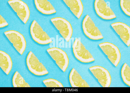 Border of lemon slices on a blue background. Flat lay summer concept. Stock Photo