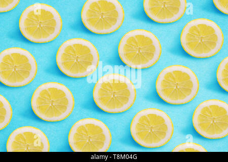 Lemon pattern on a bright blue background. Flat lay summer concept. Stock Photo