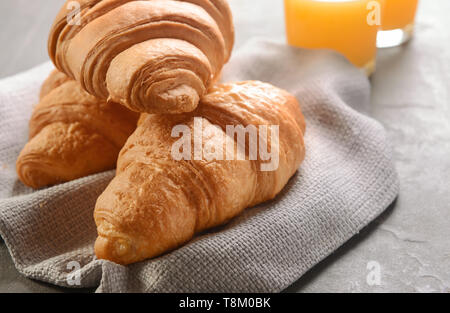 Tasty croissants on grey table Stock Photo