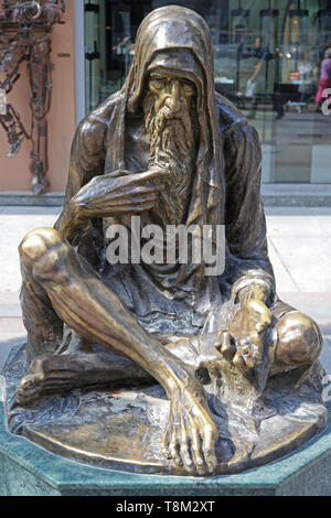 Skopje, Macedonia - September 17, 2012: Poor Old Man Bronze Beggar Sculpture in Downtown Skopje, Macedonia. Stock Photo