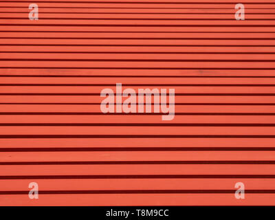 Red painted steel beams on the floor forming a linear pattern. Stock Photo