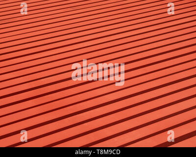 Red painted steel beams on the floor forming a linear pattern. Stock Photo