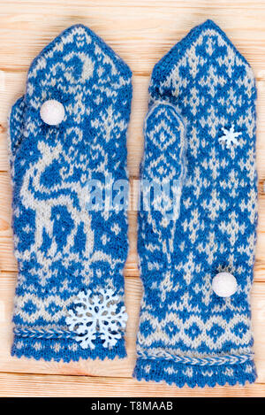 handmade blue mittens with a deer pattern are warm and soft close-ups Stock Photo
