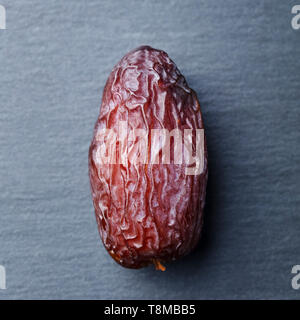 Fresh Medjool Dates. Slate stone background. Close up. Top view. Stock Photo