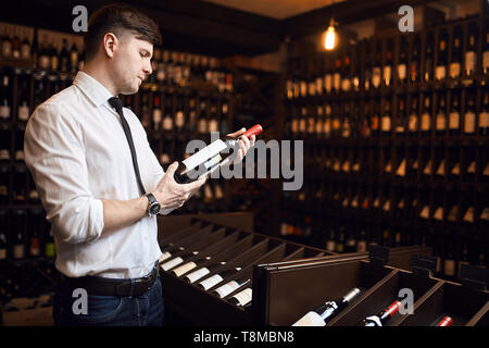 man is trained in wine tasting, pairing wine with foods, wine purchasing, wine storage Stock Photo
