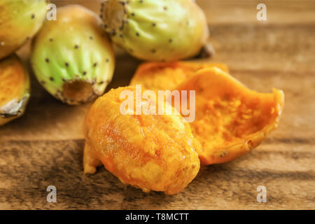 Peeled cactus pear on wooden table Stock Photo