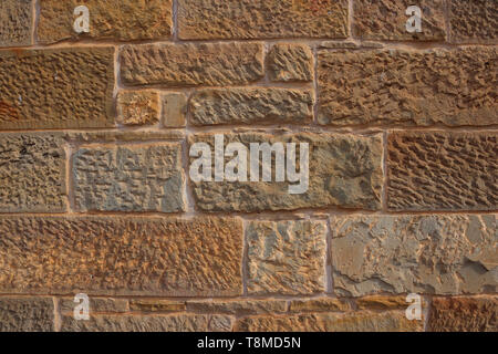 Colonial era sandstone block wall in Tasmania Australia  made by convict labour showing stipples and chisel marks background with copy space Stock Photo