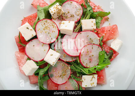 Tasty salad with watermelon, feta and radish on plate, closeup Stock Photo