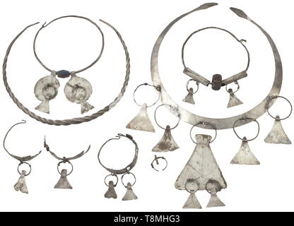A Southeast European silver set of jewellery, late Iron Age, 2nd/1st century BC A necklace made from ribbon-shaped sheet silver with embossed decoration and lancet-shaped terminals. Attached to it seven hatchet-shaped pendants, three of them connected with each other. Including a twisted necklace, two silver rings with glass beads and pendants made from sheet silver as well as two earrings, each of them with two of the originally three pendants that had been preserved. Diameters 4 to 15 cm. Provenance: Munich private collection, acquired during t, Additional-Rights-Clearance-Info-Not-Available