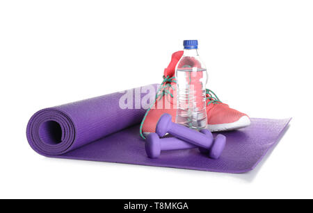 Yoga mat with sport shoes and dumbbells on pink background Stock Photo -  Alamy