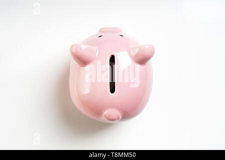 overhead view piggy or coin bank or piggybank or money box - finance and savings concept on white background with shadow Stock Photo