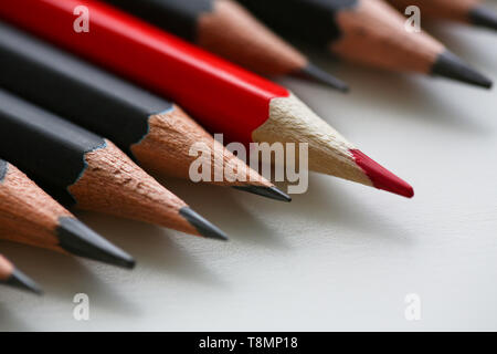 Red pencil standing out from crowd of plenty