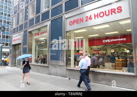 NEW YORK, USA - JULY 1, 2013: People walk by CVS Pharmacy in New York. CVS is the 2nd largest pharmacy retailer in the USA with 7,600 locations. Stock Photo