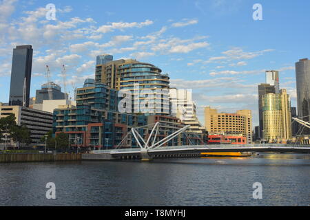 Distant view of Seafarers Bridge over Yarra River with modern buildings of Northbank in background. Stock Photo