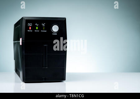 Uninterruptible power supply. Backup Power UPS with battery isolated on table. UPS for PC. Equipment for computer system at office for security. Power Stock Photo