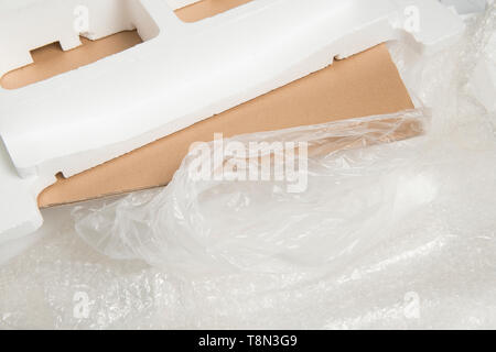 Different packaging material waste used for one item, like carton, plastic and styrofoam Stock Photo